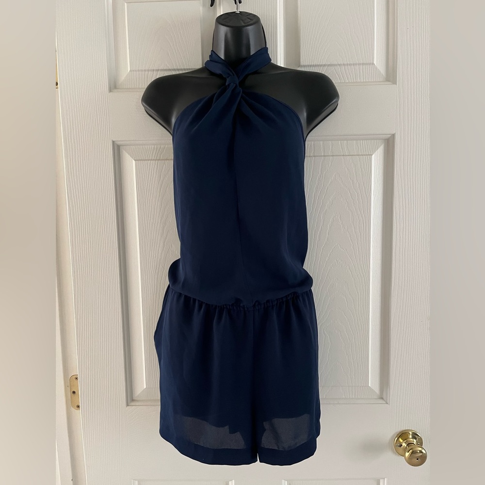 Brand new dark  blue silk romper with a halter top and pockets in size medium